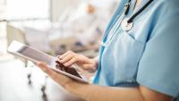 Female nurse using digital tablet in hospital